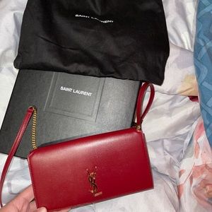 YSL monogram phone holder with leather strap.